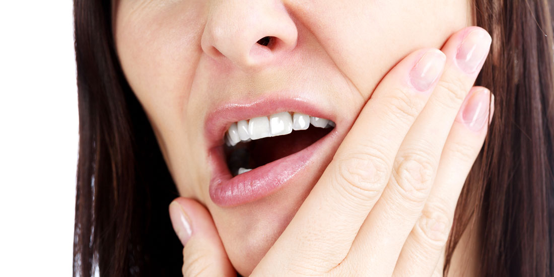 Woman Holding Jaw in Pain